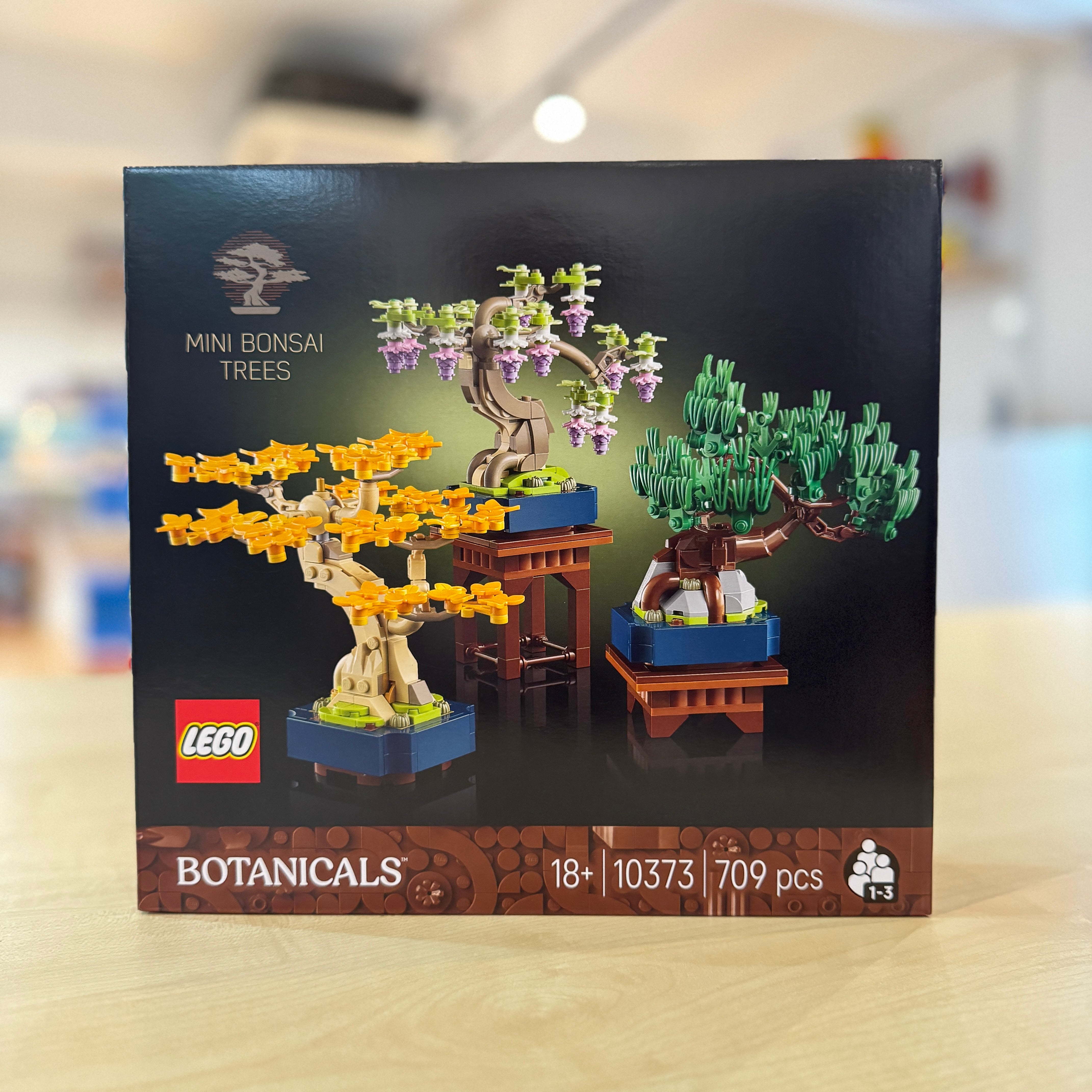 LEGO 10373 Mini Bonsai Trees set packaging on a blurred background
