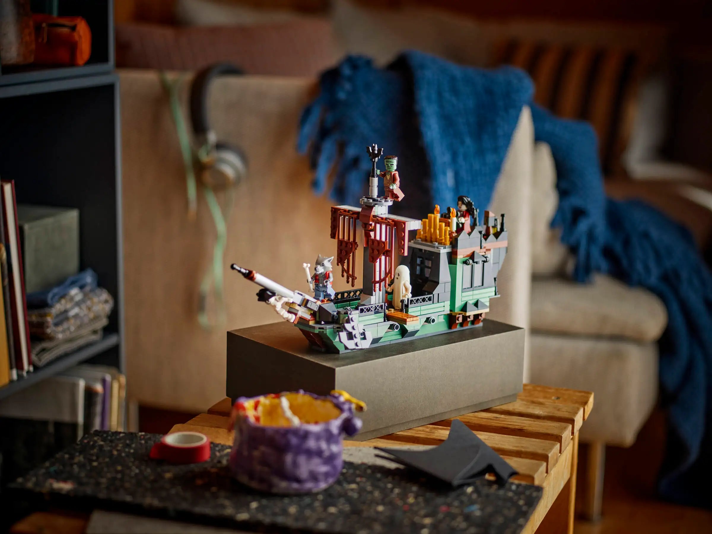 LEGO 31167 Haunted Mansion set on a table with a blurred background