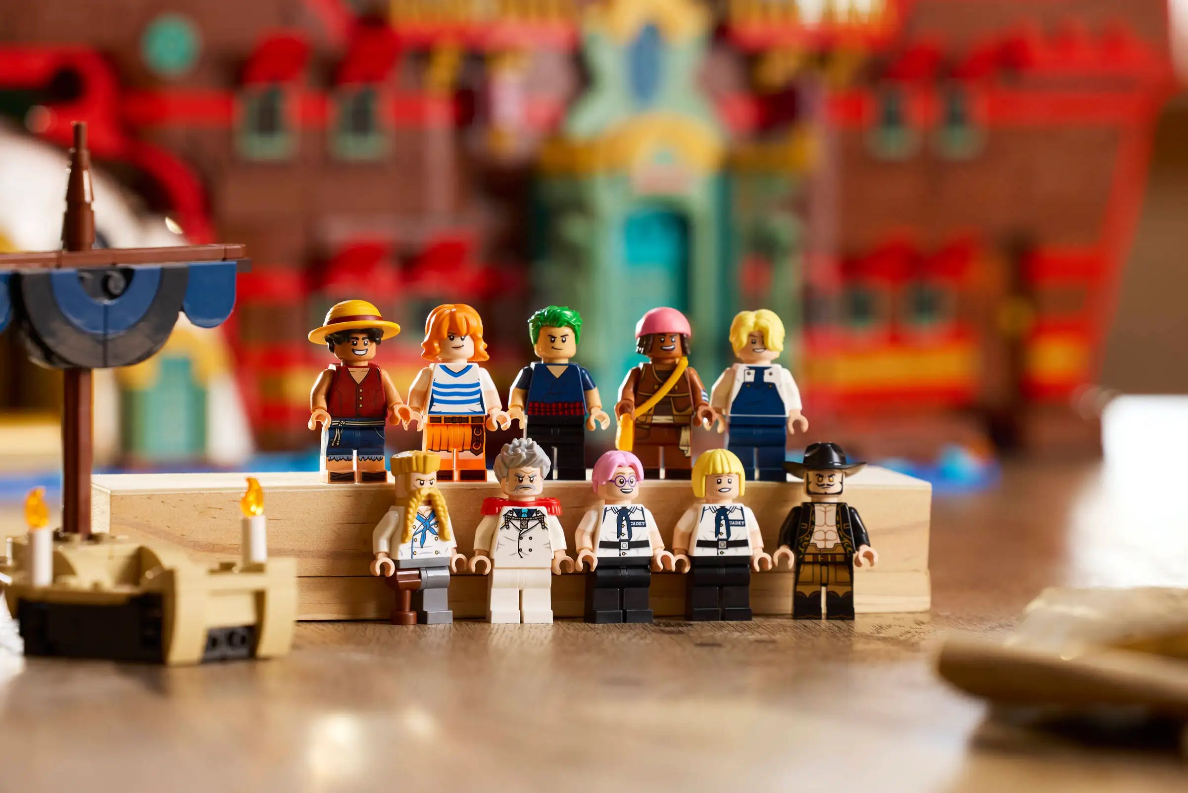 Minifigurines on a wooden platform with a colorful blurred background - LEGO 75640 The Baratie Floating Restaurant