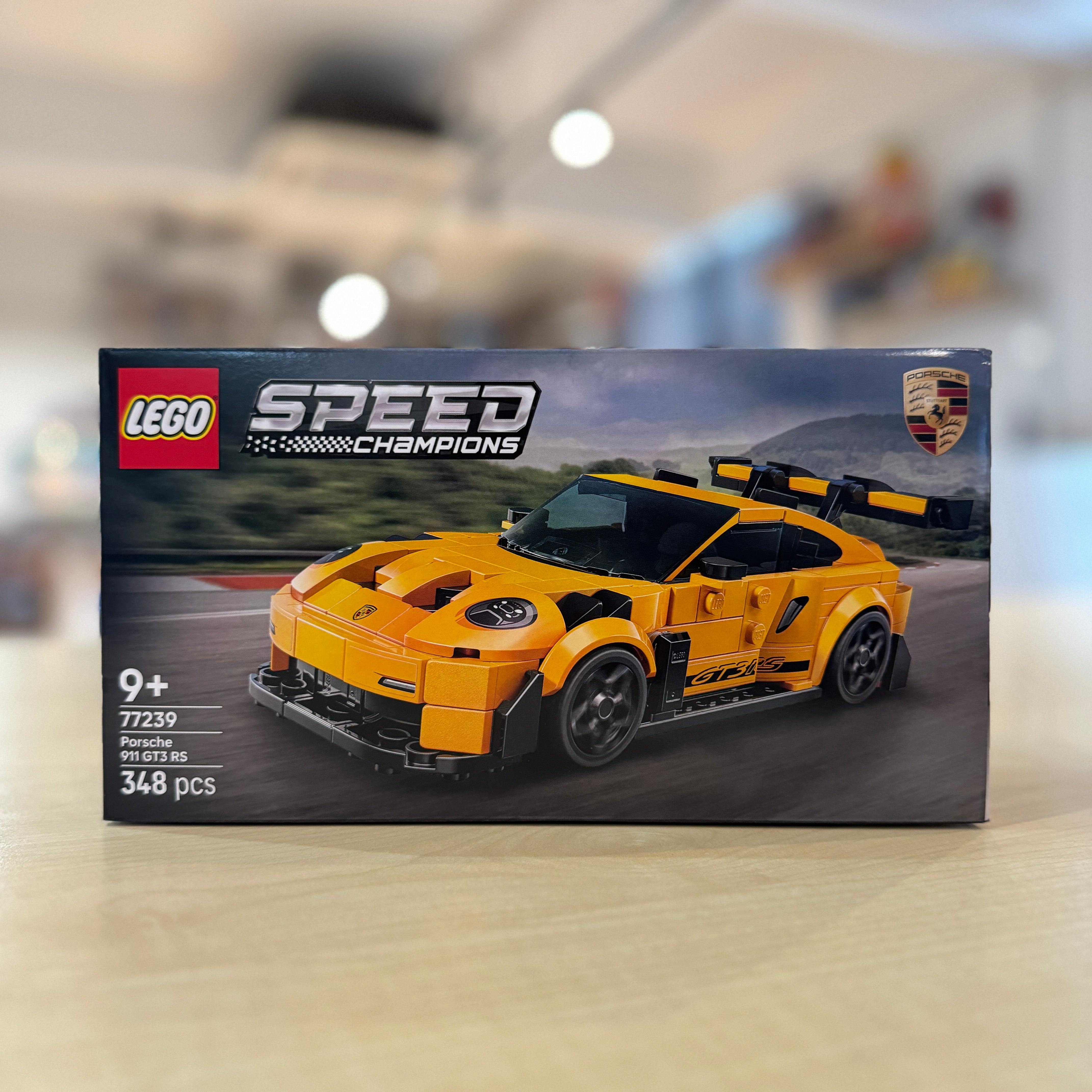 LEGO 77239 Porsche 911 GT3 RS packaging on a blurred indoor background