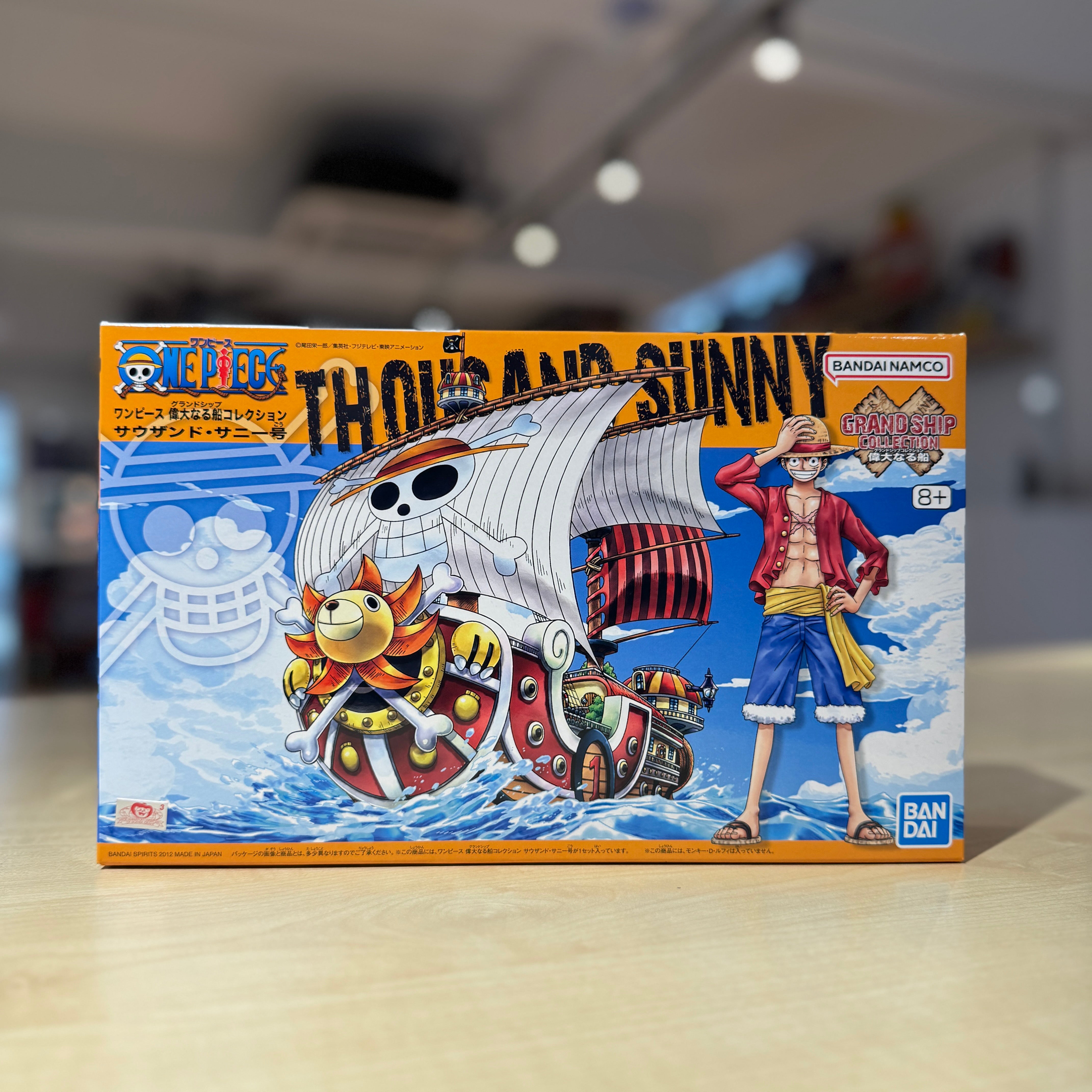 Box of 'One Piece' Thousand Sunny model kit with character and ship illustration.