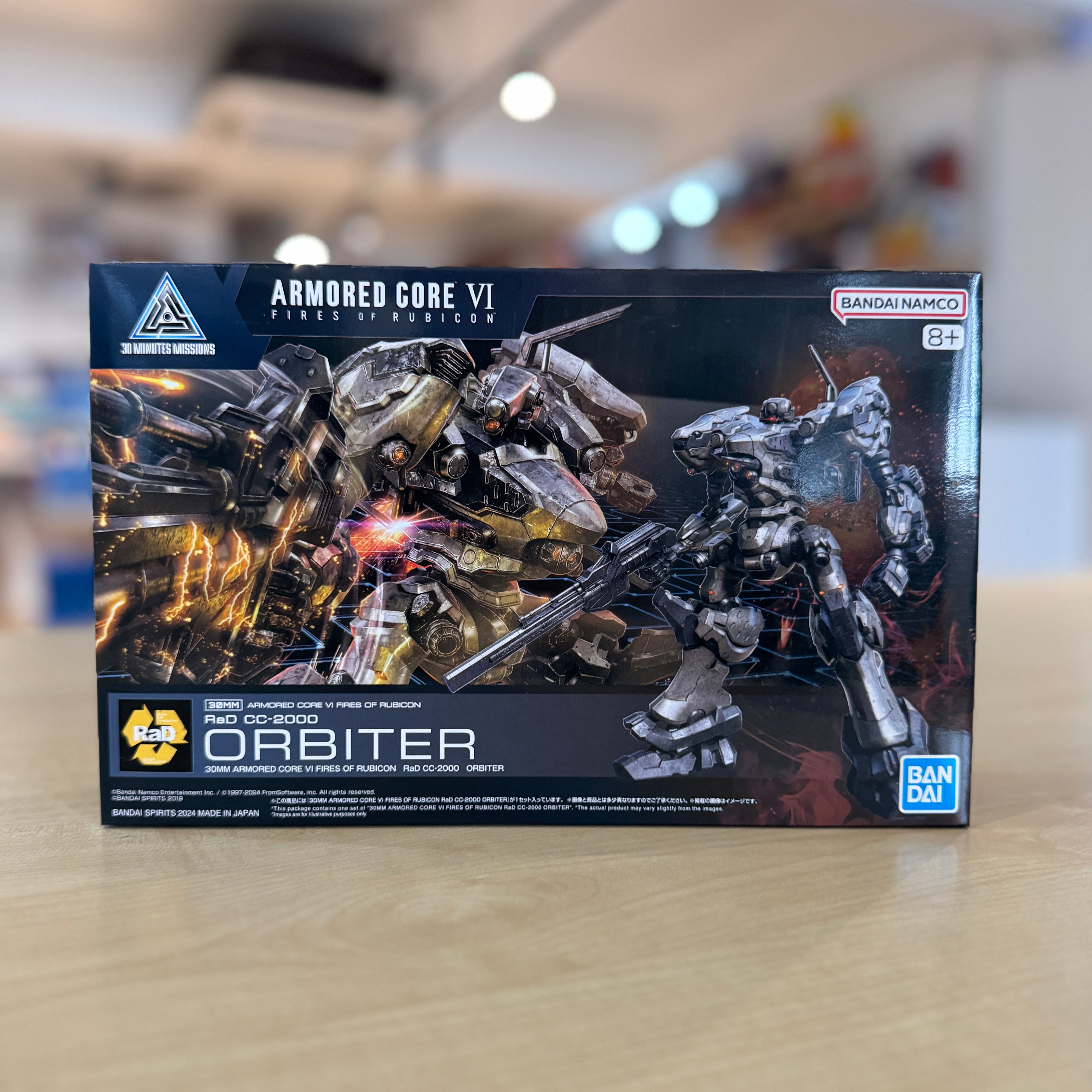 Boxed Armored Core VI figure of the Orbiter on a blurred indoor background