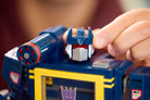 Hand interacting with LEGO 10358 Transformers: Soundwave
