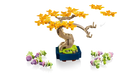 LEGO bonsai tree set with yellow flowers and small plants on a white background