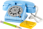 LEGO 31174 Retro Telephone set with blue casing, gray rotary dial, yellow notepad, and green pencil on a white background