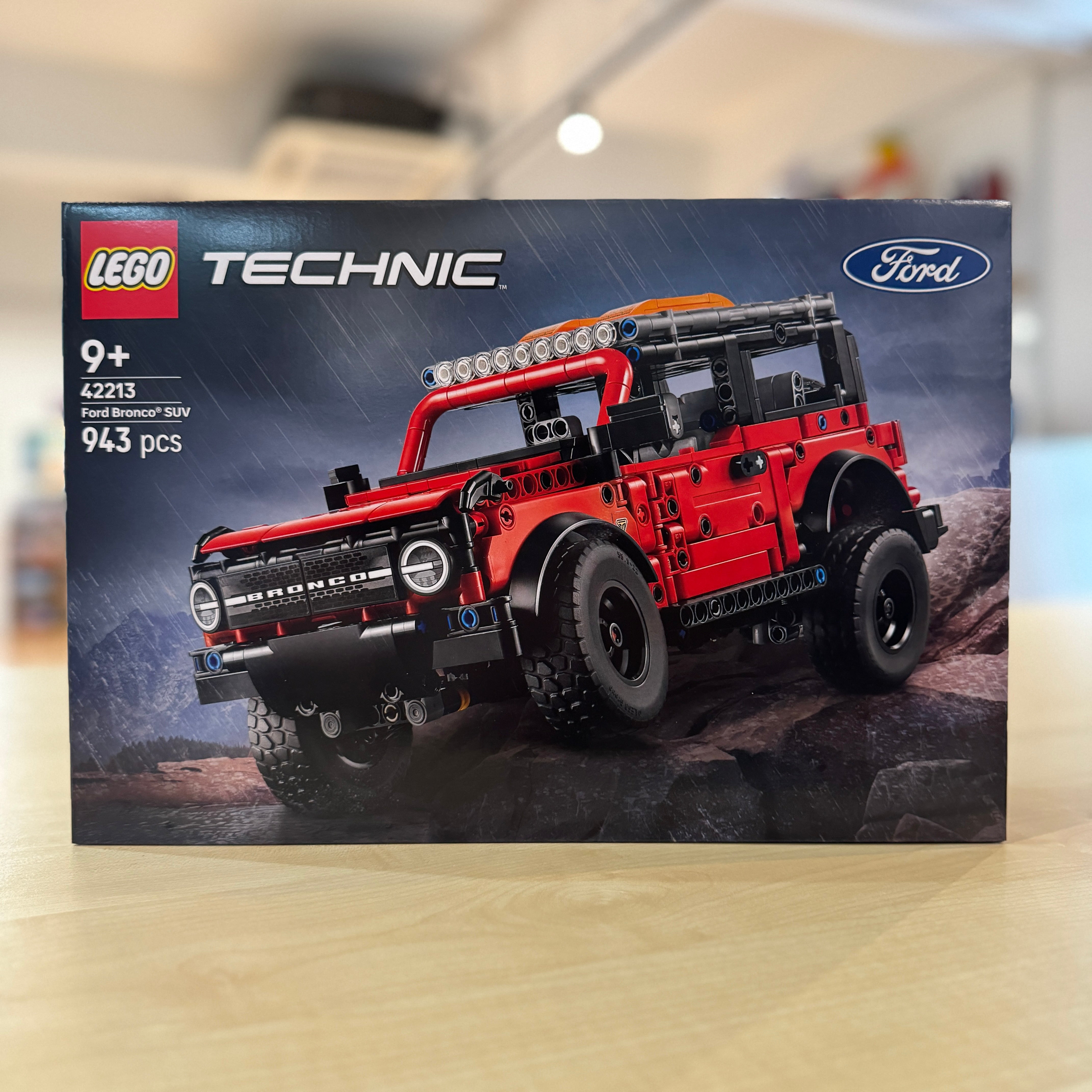 LEGO 42213 Ford Bronco SUV set packaging on a wooden surface