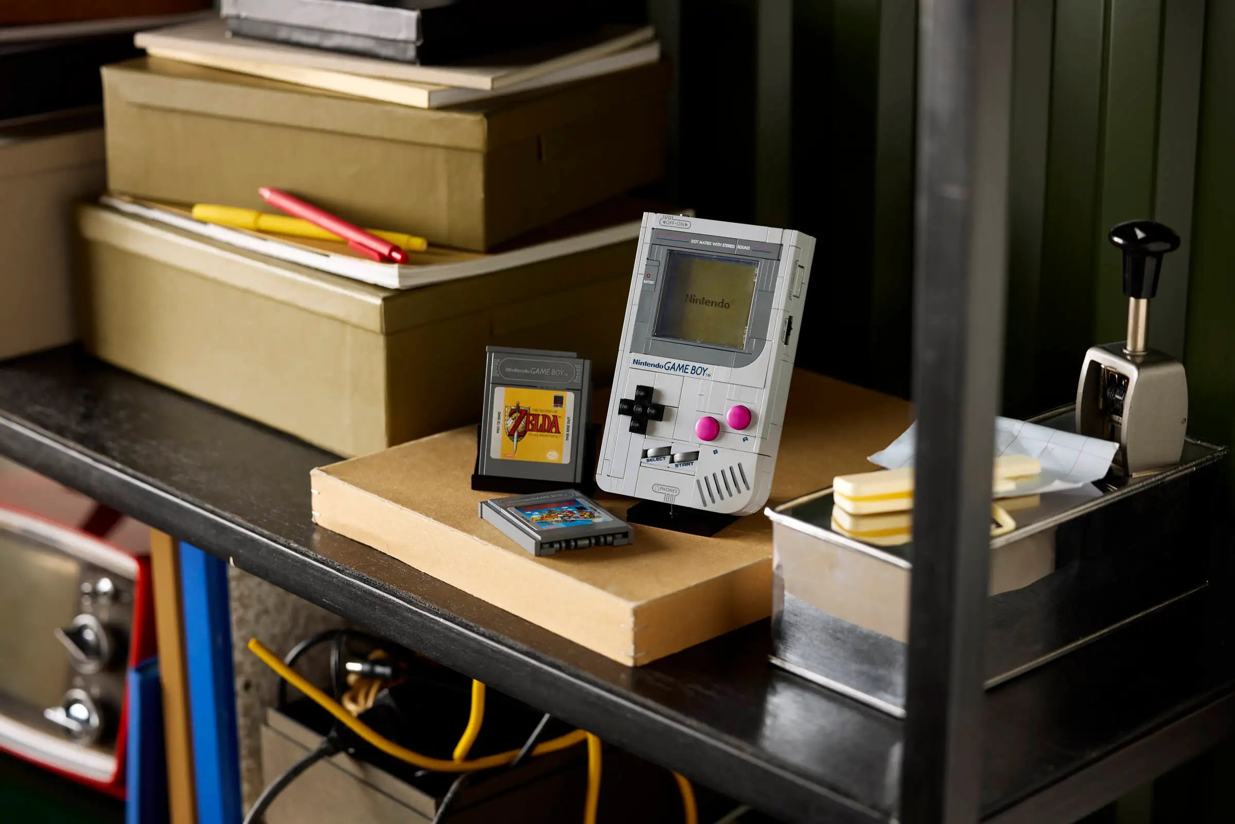 LEGO 72046 Game Boy on a shelf with books and stationery