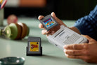 Person holding a LEGO 72046 Game Boy with a 'The Legend of Zelda' cartridge.