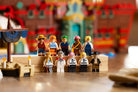 Minifigurines on a wooden platform with a colorful blurred background - LEGO 75640 The Baratie Floating Restaurant
