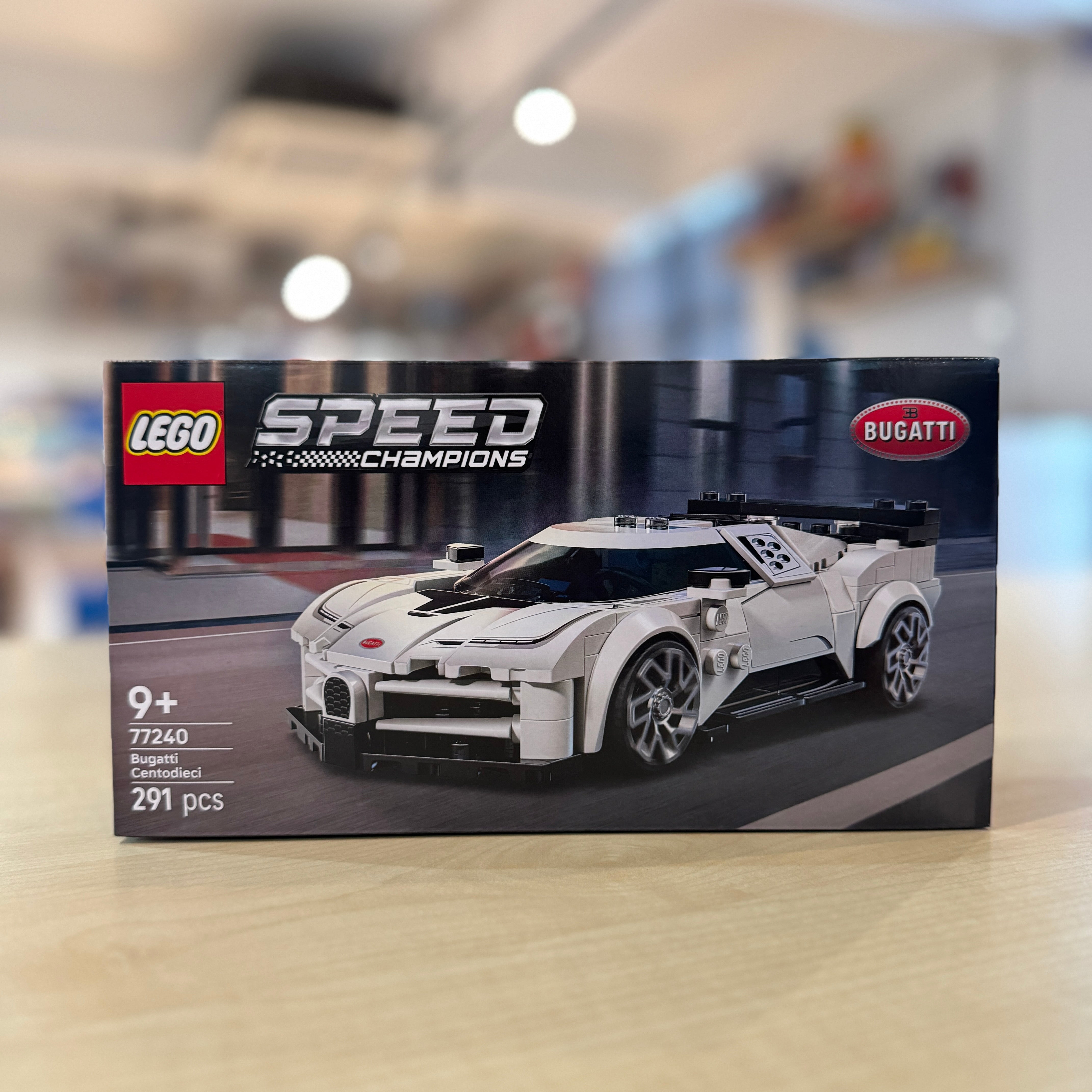 LEGO 77240 Bugatti Centodieci set packaging on a blurred indoor background