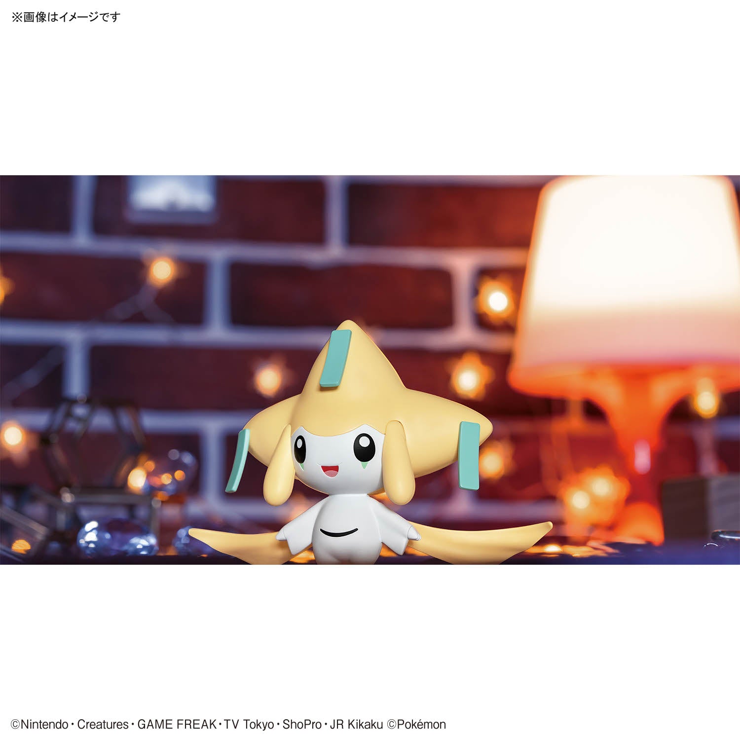 Pokémon Plamo Collection QUICK!! 23 – Jirachi figure of a cute, yellow creature with a white belly on a blurred background