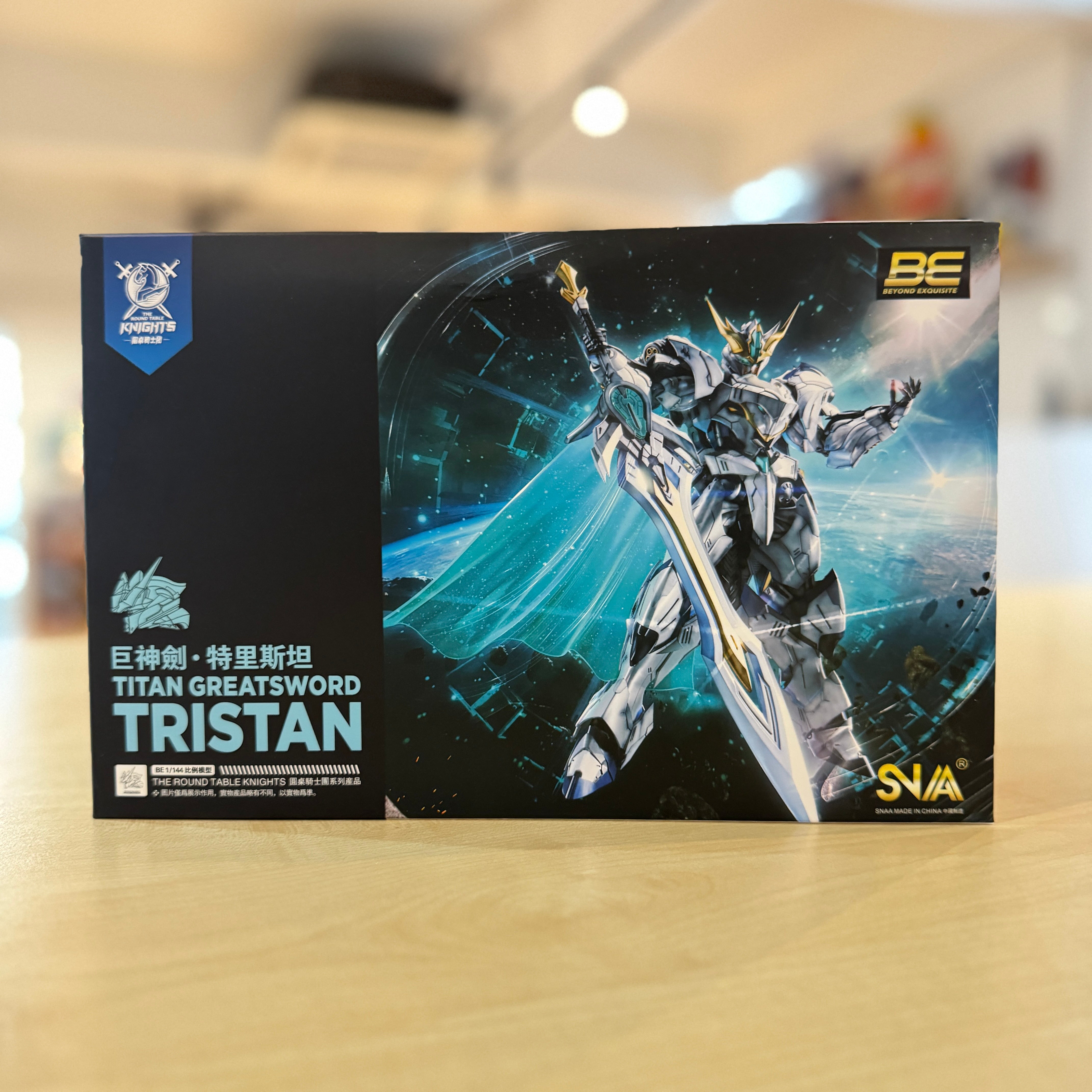 Box of a SNAA Round Table Knight Series: SC-002 Titan Great Sword model kit with a robot figure on a blurred background